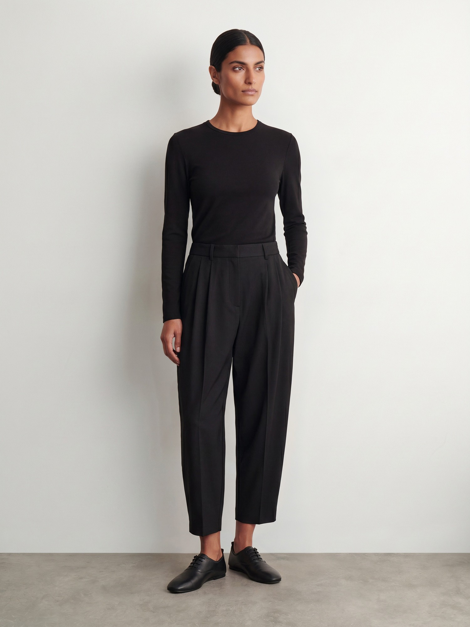 Editorial, black knit top, tapered trousers