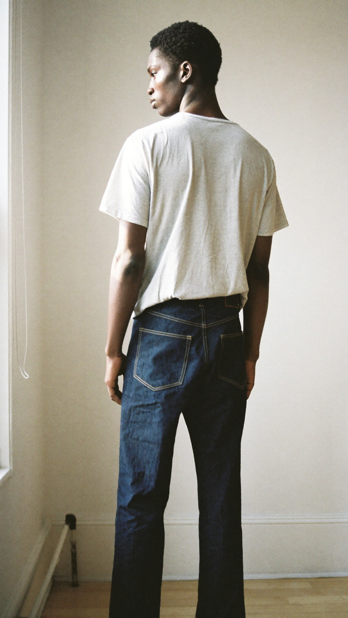 Minimal, white tee, indigo denim, back